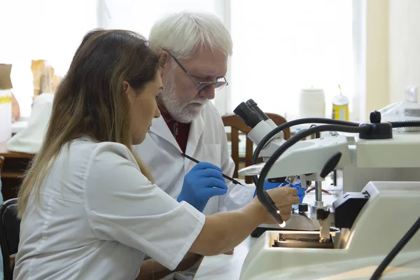 在生命科学实验室工作的保健研究人员 研究实验室年轻女科学家和高级男性主管制作和分析显微镜幻灯片 — 图库照片