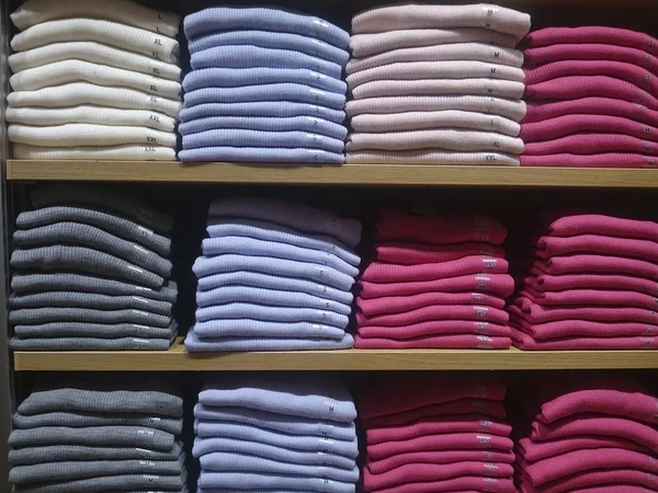 Men\'s shirts on store shelves Close-up