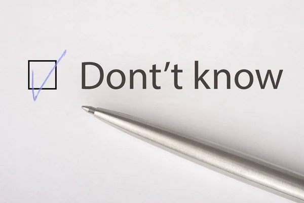 Don\'t know - checkbox with a tick on white paper with metal pen. Checklist concept. Close-up