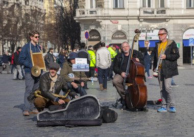 Prague, Czech Republic - March 13, 2017: Quartet of Musicians playing musical instruments for tourists on the street in Prague Portrait