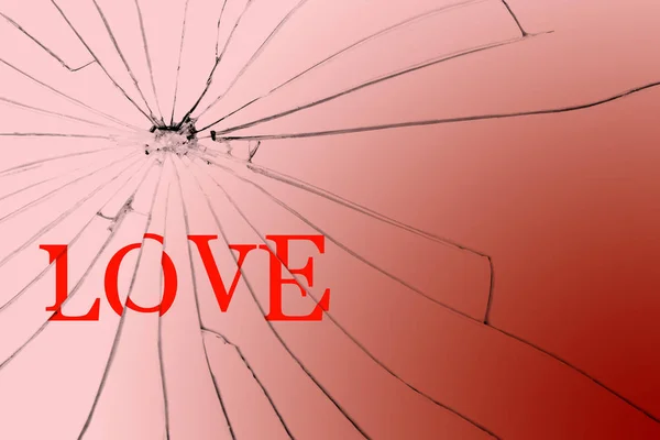 The text Love on the broken glass. Unhappy love and broken dreams. Close-up