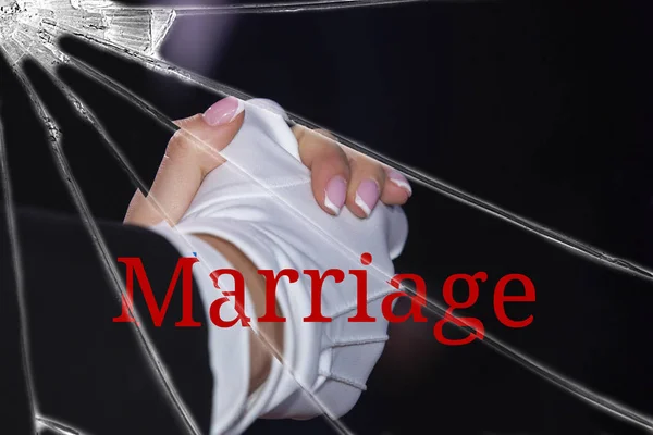 The text Marriage on the broken glass. Divorce. Loneliness concept. The background is slightly blurred. Close-up