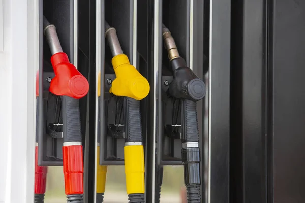 Close-up fuel nozzles on petrol and diesel fuel. Gas station pump. Man refueling gasoline with fuel in a car, holding a nozzle. Limited depth of field. — Stock Photo, Image