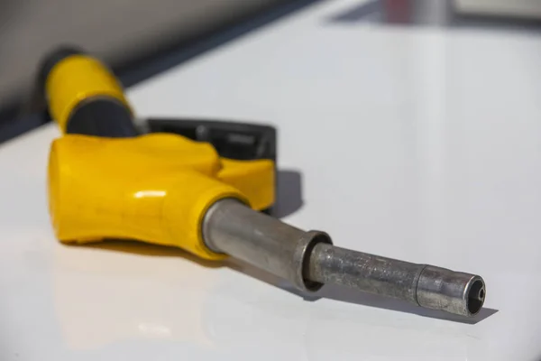 Gasoline pistol pump fuel nozzle Gas station pump. Man refueling gasoline with fuel in a car, holding a nozzle. Limited depth of field. — Stock Photo, Image