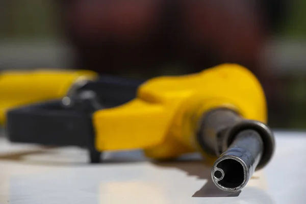 Gasoline pistol pump fuel nozzle Gas station pump. Man refueling gasoline with fuel in a car, holding a nozzle. Limited depth of field. — Stock Photo, Image