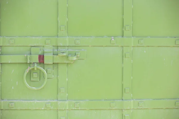 Abstract green industrial metal background texture with bolts and rivets. Old painted metal background Can be used as a background.