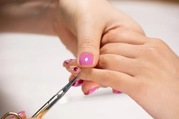 Closeup view of hands with manicure of young woman Nail treatment by a specialist in the salon — Stock Photo, Image