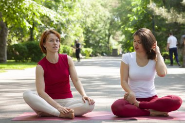 Fitness grubu park Pose ağacında yoga yapıyor. Egzersiz.