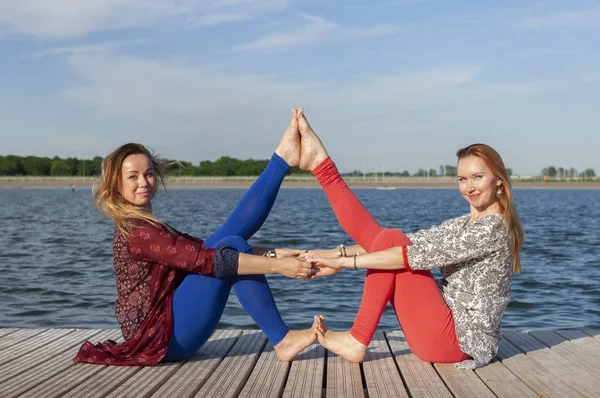 Zwei Frauen beim Sport im Park. junge schöne Frau macht zusammen Übungen im Freien. — Stockfoto