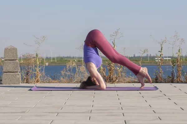Esercizio di yoga donna che fa yoga posa meditazione nel parco pubblico sport concetto sano . — Foto Stock