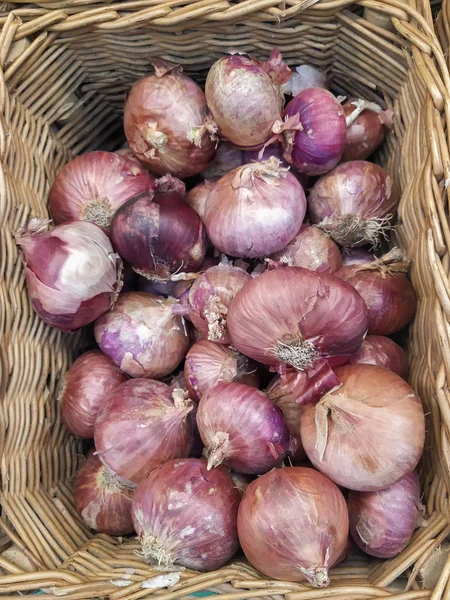 A heap of red onion Red onions background red onion sold on fresh fruit panels in Thai fresh market Plenty of Onions sold in a market