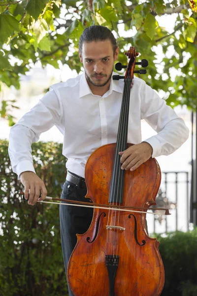 Street musiker, ung man spelar cello på gatan i Big City, närbild. — Stockfoto