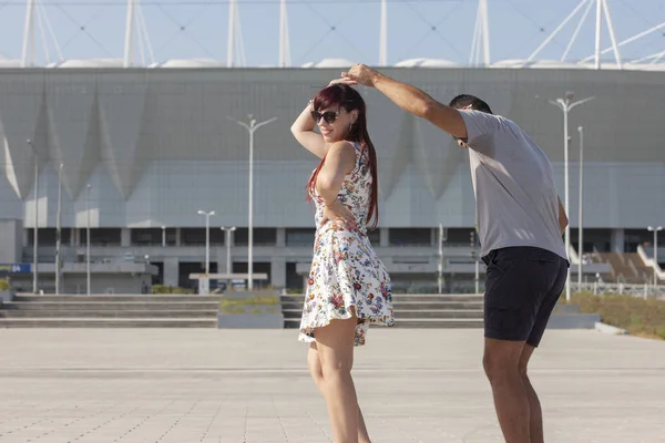 A young couple of dance instructors teaching salsa and bachata