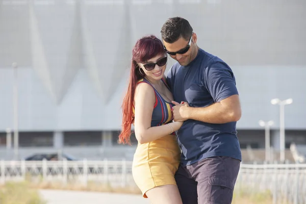 Couple dancing at sunset salsa brazilian zouk. Lovers, dance partners spinning, latin festival dance concept.