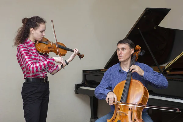 交响乐团的音乐家。 身穿音乐会服装的年轻小提琴家和大提琴家. — 图库照片