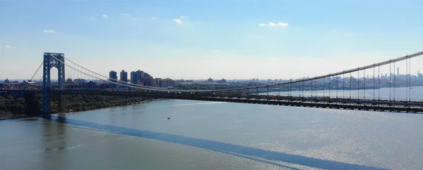 Aerial view of George Washington Bridge in Fort Lee, NJ. George Washington Bridge is a suspension bridge spanning the Hudson River connecting NJ to Manhattan, NY. Panorama of GWB during summer.