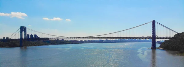 Aerial view of George Washington Bridge in Fort Lee, NJ. George Washington Bridge is a suspension bridge spanning the Hudson River connecting NJ to Manhattan, NY. Panorama of GWB during summer.