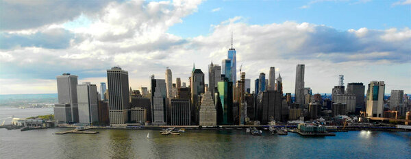 Stunning aerial view of Manhattan Skyline, New York, USA. Panoramic Skyline with skyscrapers and financial district and Hudson river from Brooklyn pier