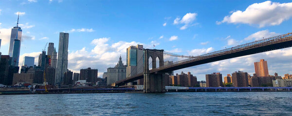 View of Brooklyn Bridge and Manhattan skyline, New York City Downtown. New York City stunning panoramic view of Brooklyn bridge and Manhattan skyline.
