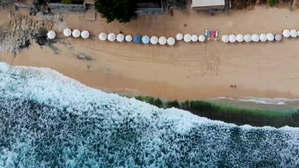 Aerial Top View Beach Sun Parasol Turquoise Sea Waves Bali — Stock Video