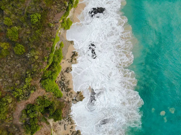 在沙质海岸线上有岩石悬崖的蓝色大海鸟图 美丽的绿松石海水与海浪冲浪在夏季在巴厘岛 美丽的印度洋景观 度假胜地 — 图库照片