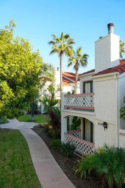 Tipik Güney Kaliforniya, İspanyolca güzel bahçe ağaçları ve palmiye ağaçları ile çevrili konut tarzı. San Diego, Kaliforniya, ABD