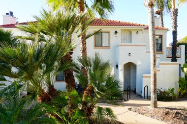 Tipik Güney Kaliforniya, İspanyolca güzel bahçe ağaçları ve palmiye ağaçları ile çevrili konut tarzı. San Diego, Kaliforniya, ABD