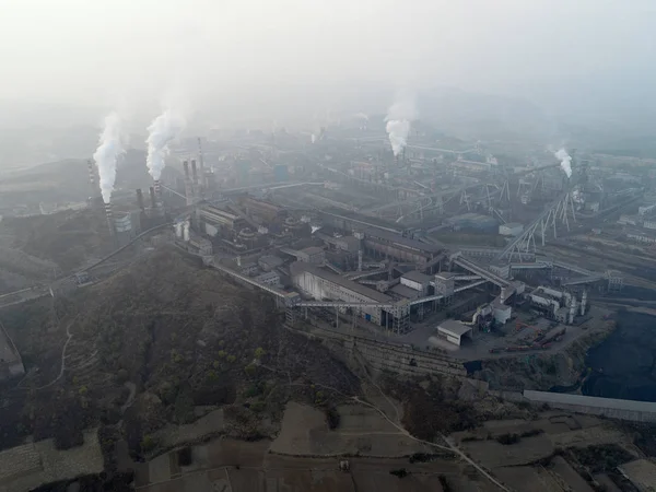 Aerial view of big factory in China.Air pollution by smoke coming out of chimneys. Coal Fossil Fuel Power Plant Smokestacks Emit Carbon Dioxide Pollution. Chengde, China.