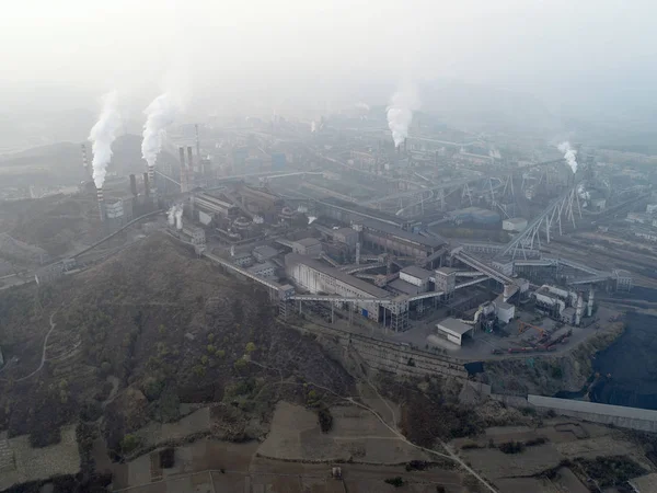 Aerial view of big factory in China.Air pollution by smoke coming out of chimneys. Coal Fossil Fuel Power Plant Smokestacks Emit Carbon Dioxide Pollution. Chengde, China.