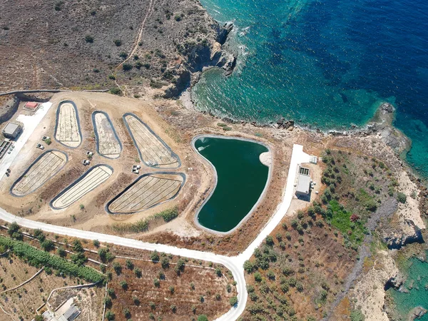 Aerial view of of water reservoir on the Greece coastline, with beautiful blue water during summer. Summer dry coastline, turquoise sea and fine sand in Greece, Europe
