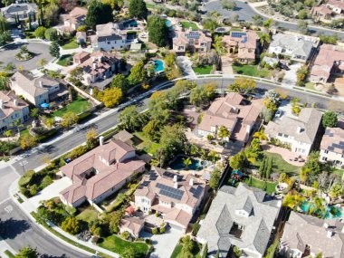 Aerial view suburban neighborhood with identical wealthy villas next to each other. San Diego, California, USA. Aerial view of residential modern subdivision luxury house with swimming pool. clipart