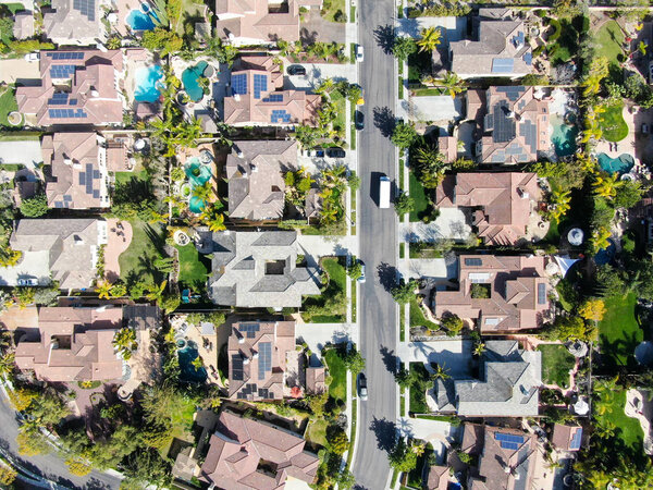 Aerial view suburban neighborhood with identical wealthy villas next to each other. San Diego, California, USA. Aerial view of residential modern subdivision luxury house with swimming pool.