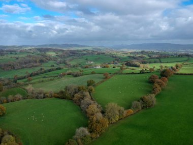 Aerial view of beautiful valley in mid Wales. Green landscape with small valley. Aerial drone view of rural Wales clipart