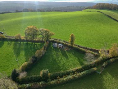 Aerial view of little hut in beautiful valley in mid Wales. Green landscape with small valley. Aerial drone view of rural Wales clipart