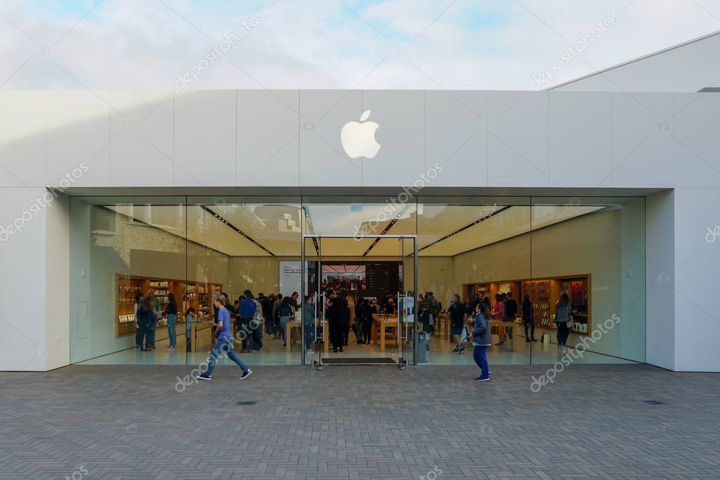 Apple retail store selling iPhones, iPads & more in sleekly designed spaces. located in Westfield UTC. with pedestrians passing by outside the store. La Jolla. San Diego, California, USA. 03/22/2019