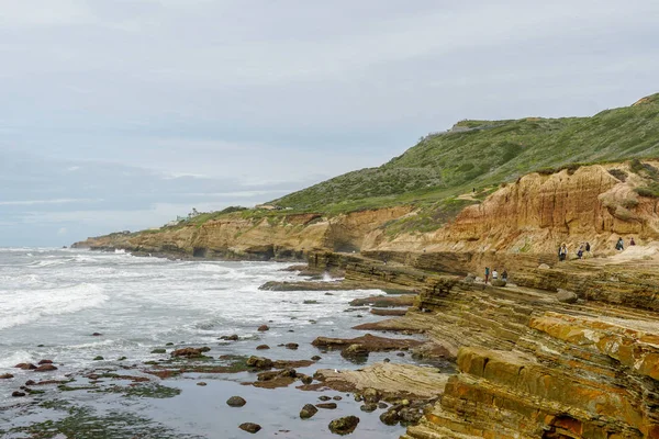 Park rangers at the Point Loma tide pools. Layers of rock in the sandstone of tide pool area, part of the Cabrillo National Monument in San Diego, CA. USA