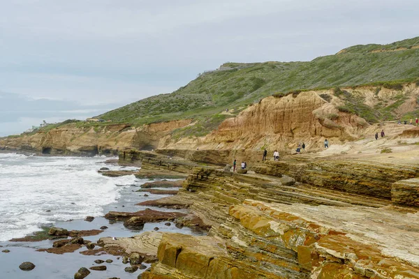 Park rangers at the Point Loma tide pools. Layers of rock in the sandstone of tide pool area, part of the Cabrillo National Monument in San Diego, CA. USA