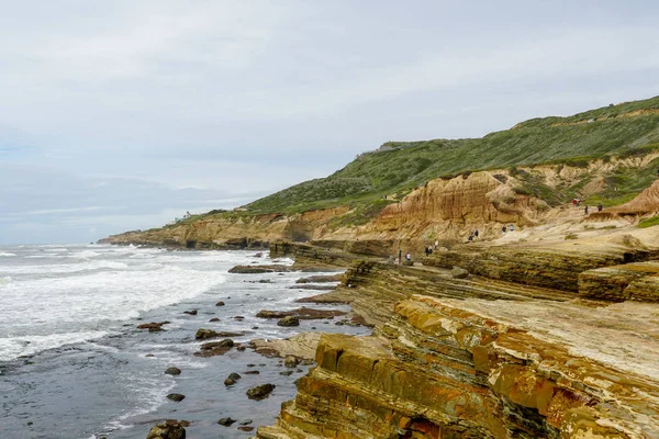 Park rangers at the Point Loma tide pools. Layers of rock in the sandstone of tide pool area, part of the Cabrillo National Monument in San Diego, CA. USA