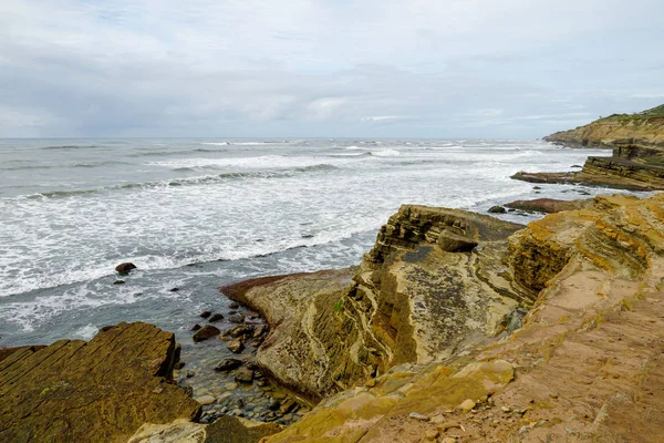 Park rangers at the Point Loma tide pools. Layers of rock in the sandstone of tide pool area, part of the Cabrillo National Monument in San Diego, CA. USA