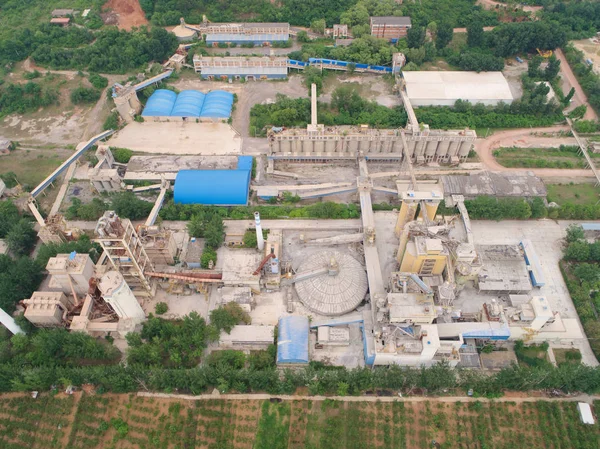 Aerial view of factory in the middle of thr mountain and green farm land, in the area of Huaibei, China. Industrial factory, pollution.