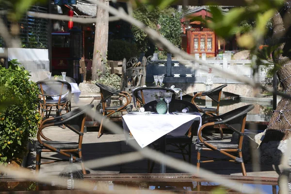 Restaurant terrace with table in the sun and flower