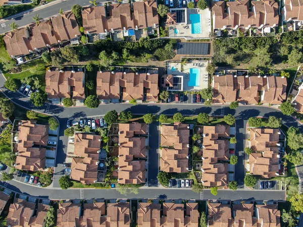 Aerial view suburban neighborhood with identical villas next to each other in the valley. San Diego, California, USA. Aerial view of residential modern subdivision luxury house with swimming pool.