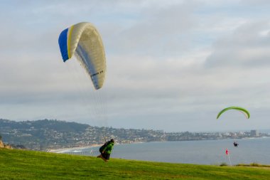 Adam spor yapıyor (para-planör). Bulutlu gökyüzünde bir adam yamaç paraşütü. Paragliding aşırı bir spor ve rekreasyon olduğunu. Torrey Pines Gliderport. San Diego 'da. Kaliforniya, ABD. 