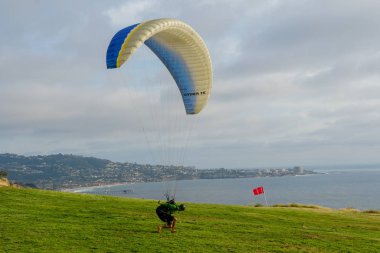 Adam spor yapıyor (para-planör). Bulutlu gökyüzünde bir adam yamaç paraşütü. Paragliding aşırı bir spor ve rekreasyon olduğunu. Torrey Pines Gliderport. San Diego 'da. Kaliforniya, ABD. 