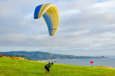 Adam spor yapıyor (para-planör). Bulutlu gökyüzünde bir adam yamaç paraşütü. Paragliding aşırı bir spor ve rekreasyon olduğunu. Torrey Pines Gliderport. San Diego 'da. Kaliforniya, ABD. 