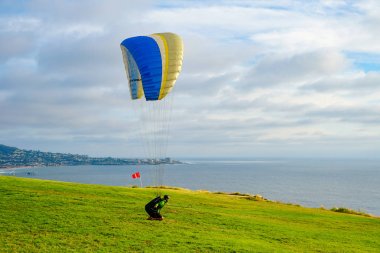 Adam spor yapıyor (para-planör). Bulutlu gökyüzünde bir adam yamaç paraşütü. Paragliding aşırı bir spor ve rekreasyon olduğunu. Torrey Pines Gliderport. San Diego 'da. Kaliforniya, ABD. 