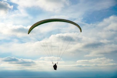 Adam spor yapıyor (para-planör). Bulutlu gökyüzünde bir adam yamaç paraşütü. Paragliding aşırı bir spor ve rekreasyon olduğunu. Torrey Pines Gliderport. San Diego 'da. Kaliforniya, ABD. 