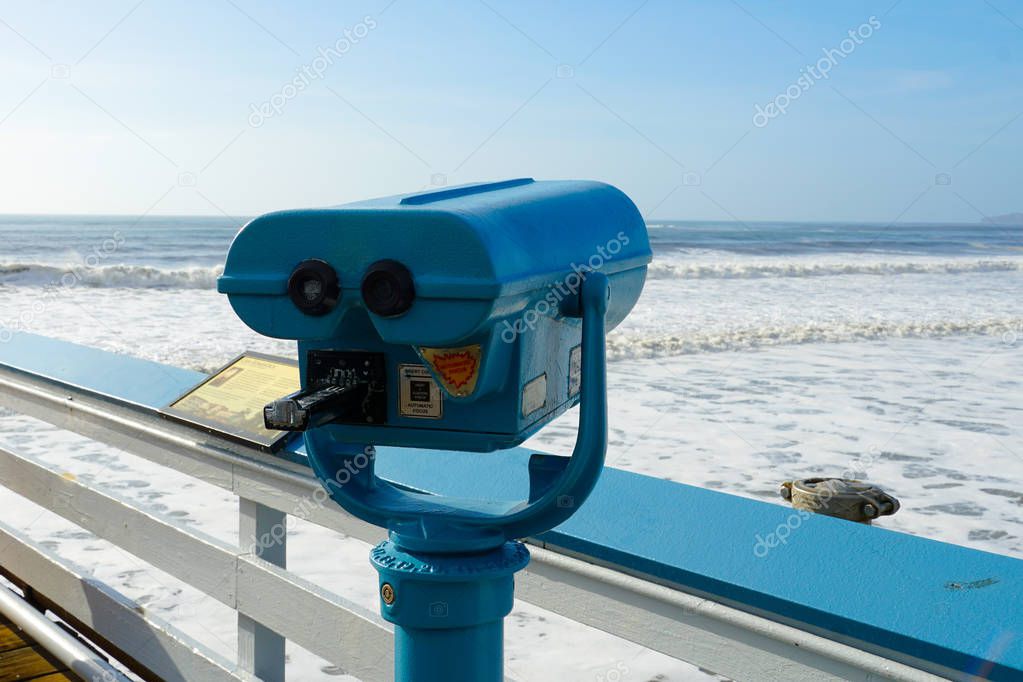 Sightseeing binoculars with Beach background San Clemente Pier in Orange County, California, USA. Travel destination in the South West Coast.
