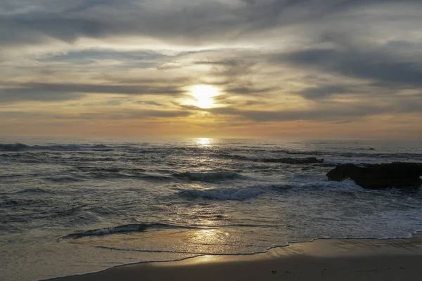 Beautiful colorful sunset over the sea, clouded sky on twilight time and reflection on the sea. in La Jolla, San Diego, California, USA