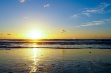 Deniz üzerinde güzel renkli günbatımı, alacakaranlık zaman güzel gökyüzü ve denizde yansıma.